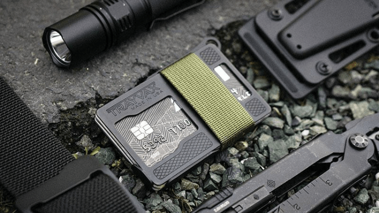 Armored Summit Laying on Rocks next to a Black Multi-Tool, Flashlight, Black Kydex Sheath, and Black Designer Cinch Belt